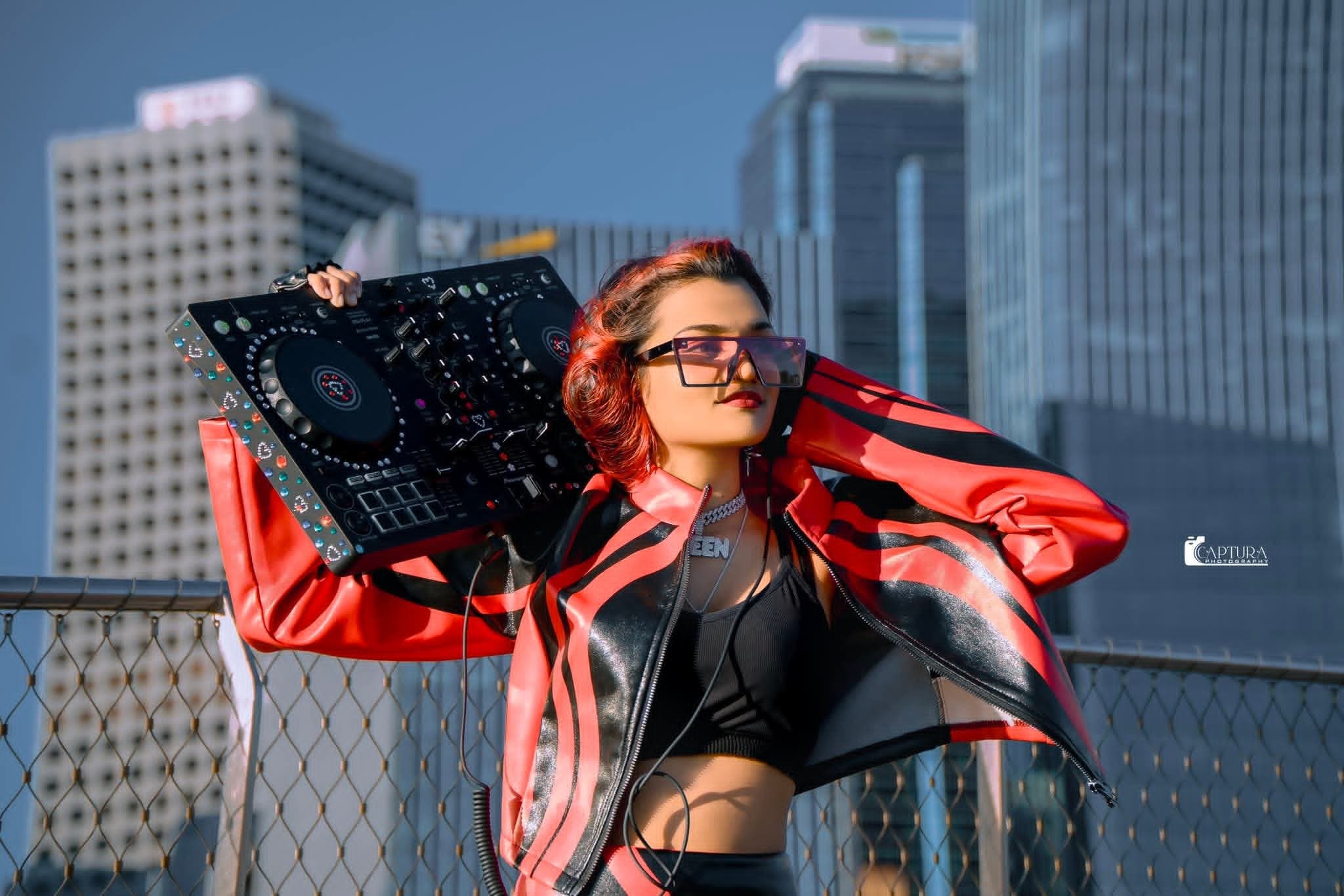 DJ KIZA performing with a DJ controller